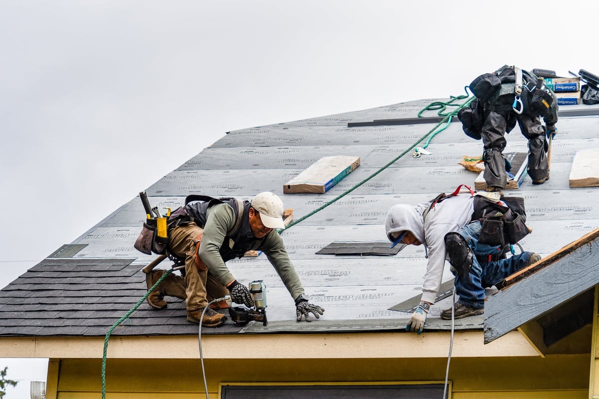 Roofing crew working on new shingle installation
