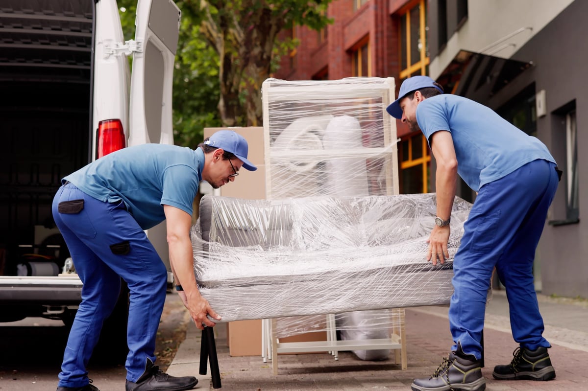 Professional movers delivering office furniture removal service
